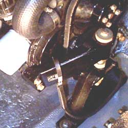 Spare belt pre-threaded through the motor mount.